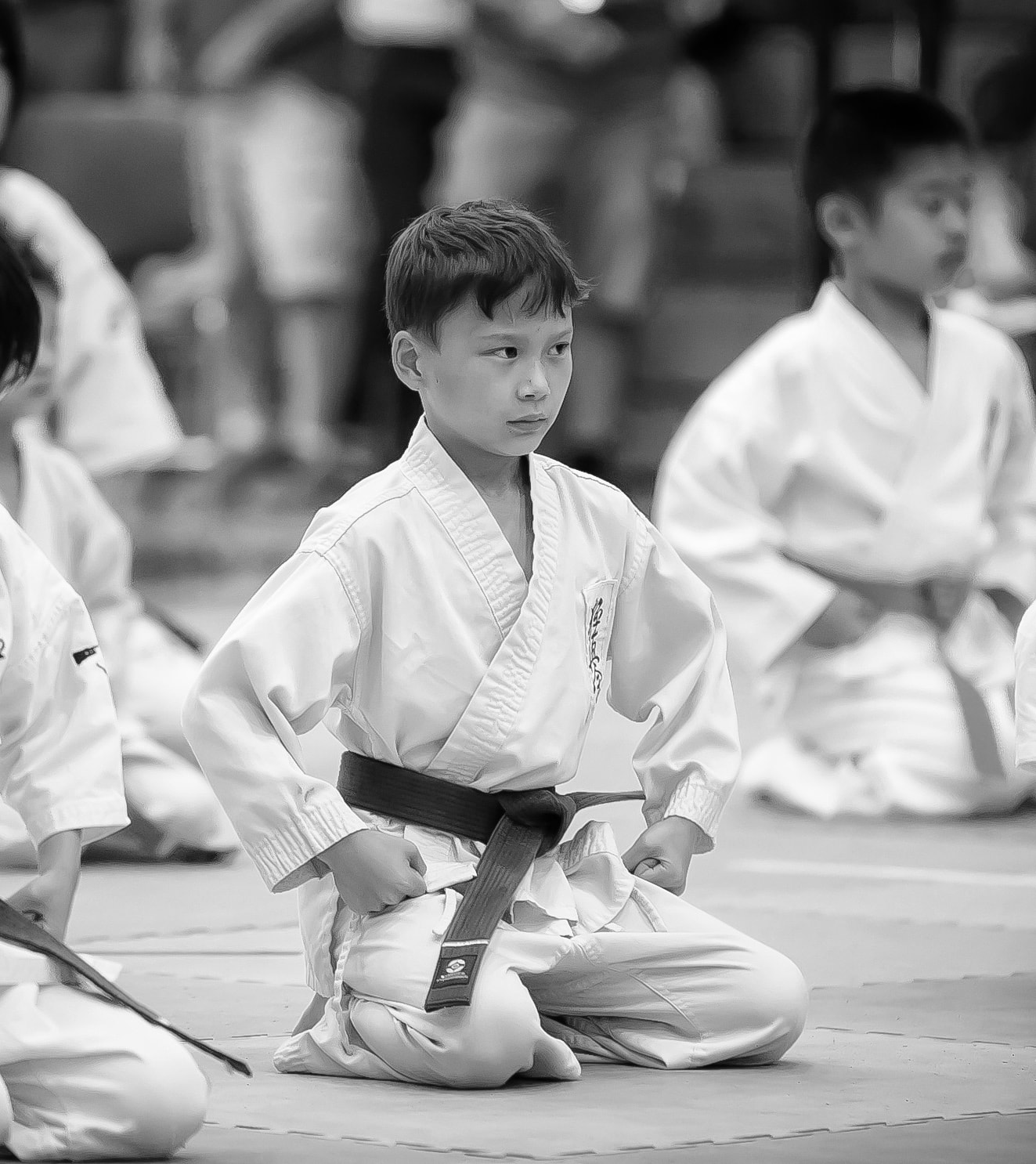 A KKNY instructor helping a young student with technique during kids class